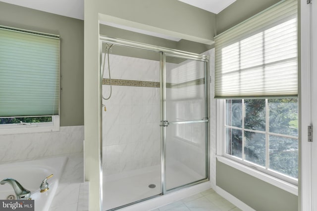 full bath with baseboards, tile patterned flooring, a shower stall, and a garden tub