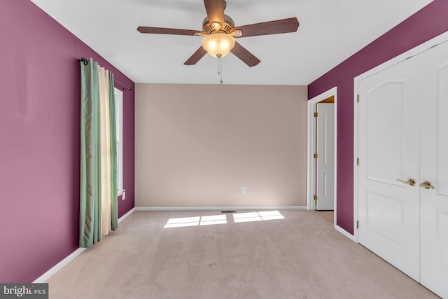 unfurnished bedroom with carpet flooring, baseboards, and ceiling fan