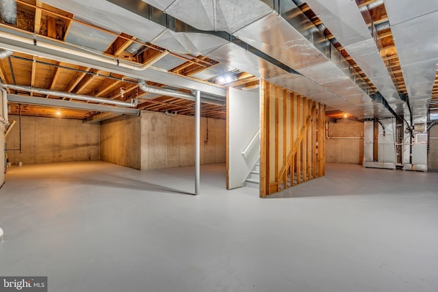 unfinished below grade area with heating unit and stairs