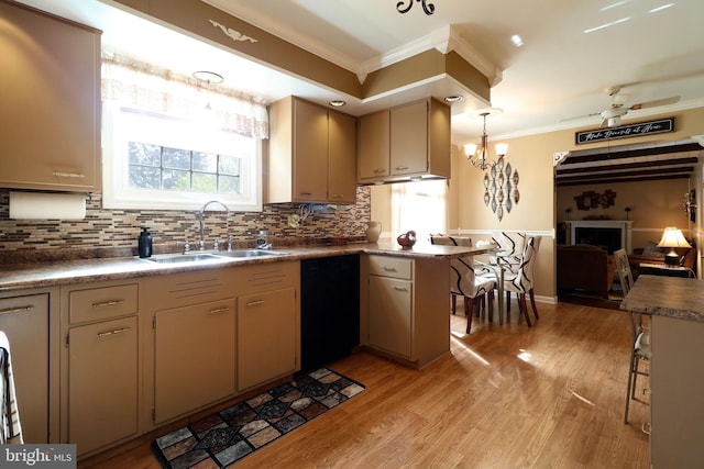kitchen with a sink, light wood finished floors, dishwasher, tasteful backsplash, and ornamental molding