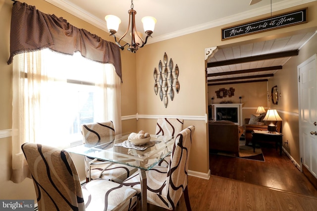 dining area featuring ornamental molding, wood finished floors, beamed ceiling, wooden ceiling, and a notable chandelier