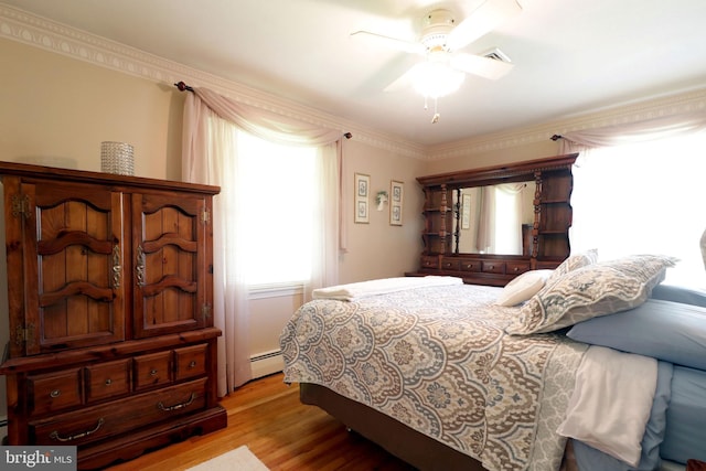 bedroom with light wood-style floors, ornamental molding, visible vents, and multiple windows