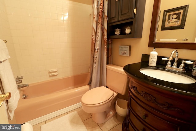 bathroom featuring tile patterned flooring, shower / tub combo, toilet, and vanity