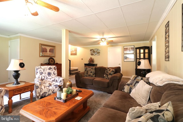 living room with dark carpet, a ceiling fan, and ornamental molding