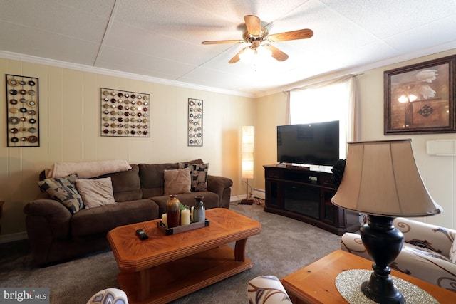 carpeted living area with a ceiling fan, ornamental molding, and baseboard heating