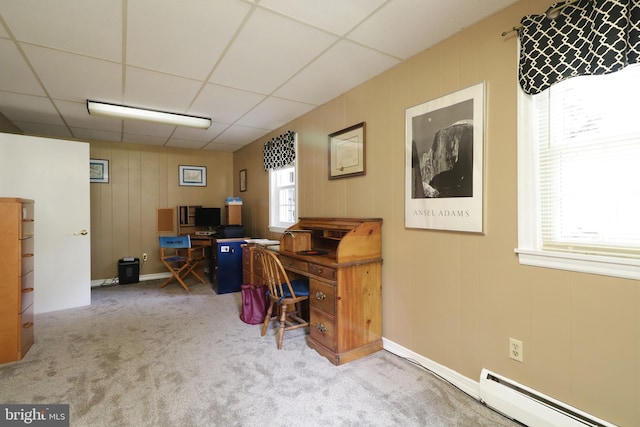 office space with carpet, a baseboard heating unit, and a paneled ceiling