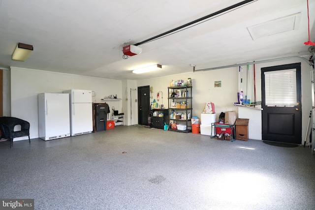garage with freestanding refrigerator and a garage door opener