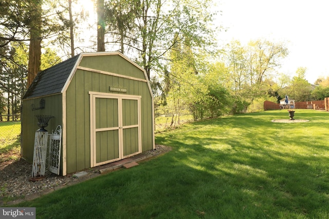 view of shed featuring fence