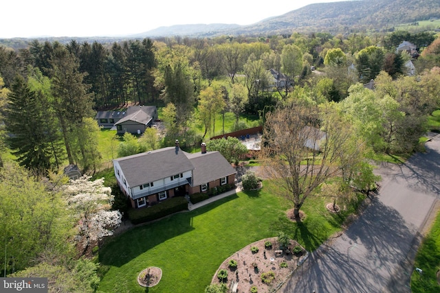 bird's eye view featuring a view of trees and a mountain view