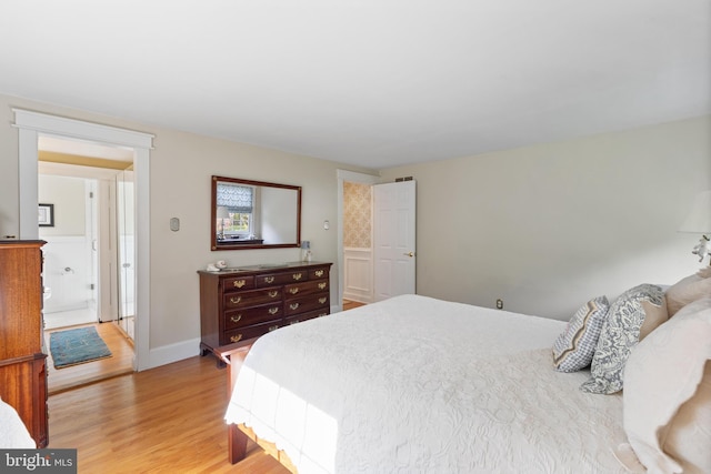 bedroom featuring light wood-type flooring and baseboards