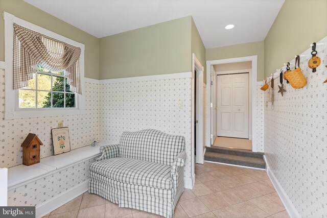 living area featuring baseboards and light tile patterned floors