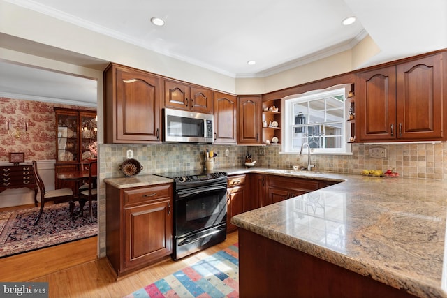 kitchen with black electric range, crown molding, a sink, light stone counters, and stainless steel microwave