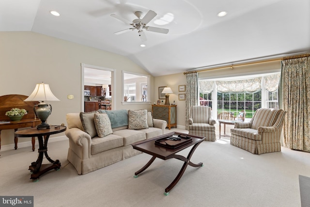 carpeted living area featuring baseboards, a ceiling fan, recessed lighting, and lofted ceiling