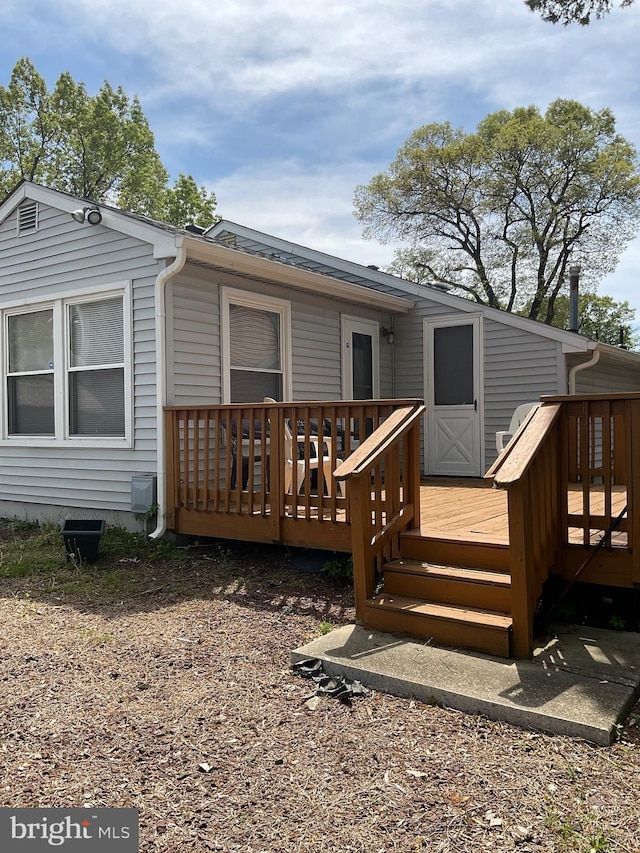 rear view of property featuring a deck