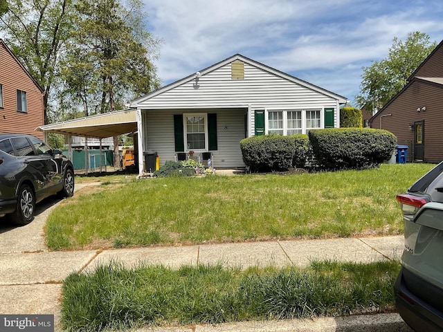 bungalow-style house with an attached carport and a front lawn