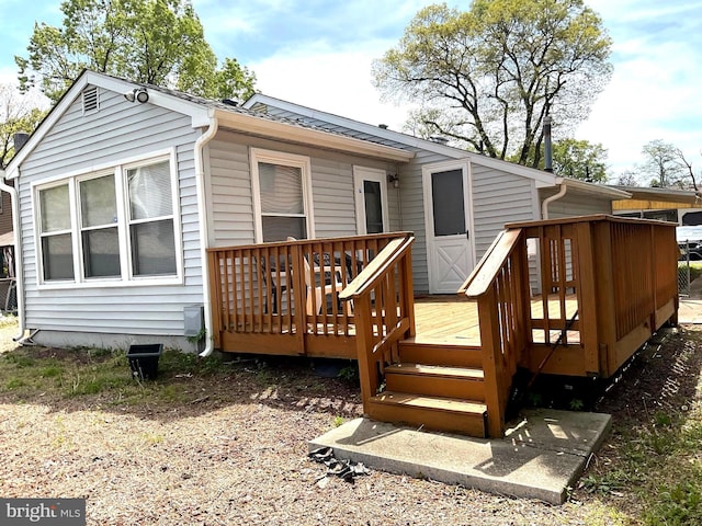 rear view of property with a wooden deck
