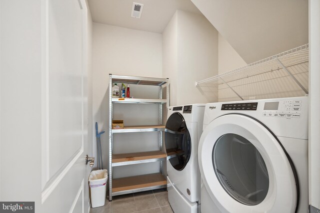washroom featuring laundry area, tile patterned flooring, separate washer and dryer, and visible vents