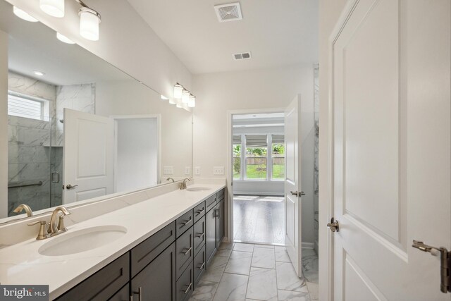 full bathroom featuring visible vents, a marble finish shower, a sink, and marble finish floor