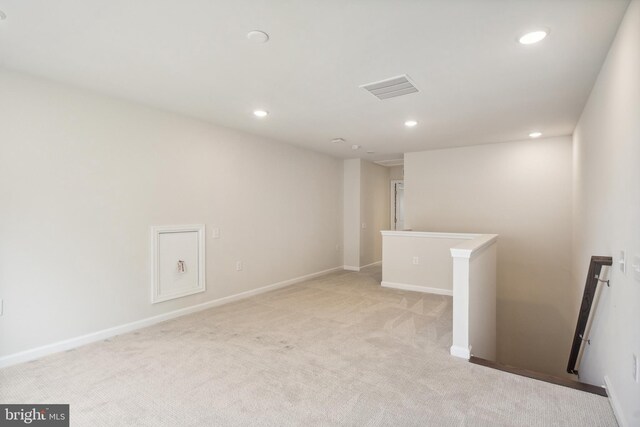 below grade area featuring baseboards, light carpet, recessed lighting, and visible vents