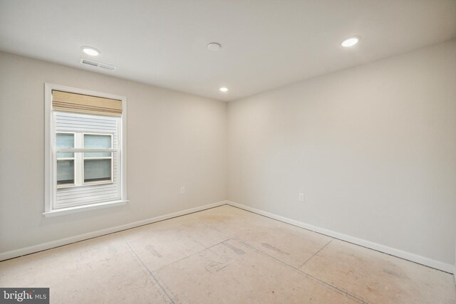 spare room featuring baseboards, recessed lighting, and visible vents