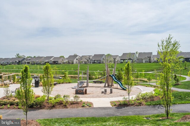 community play area featuring a yard and a residential view