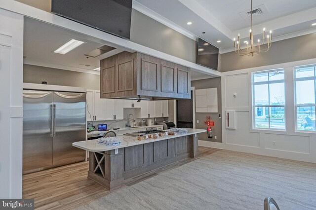 kitchen with an inviting chandelier, stainless steel appliances, a large island, recessed lighting, and visible vents