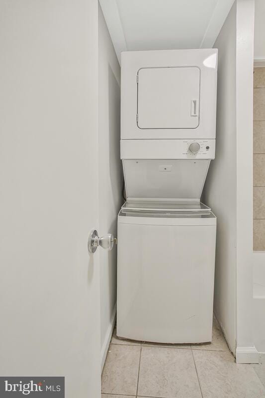 5018 Quimby Ave, Beltsville, MD 20705 - laundry area with stacked washer / drying machine, baseboards, and light tile patterned floors