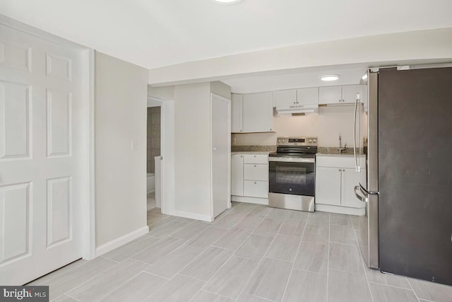 5018 Quimby Ave, Beltsville, MD 20705 - kitchen with appliances with stainless steel finishes, under cabinet range hood, white cabinets, and baseboards
