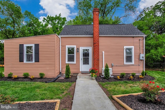 5018 Quimby Ave, Beltsville, MD 20705 - view of front of home featuring a chimney, a front yard, a shingled roof, and cooling unit