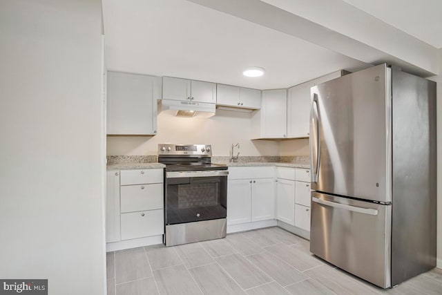 5018 Quimby Ave, Beltsville, MD 20705 - kitchen with appliances with stainless steel finishes, under cabinet range hood, white cabinetry, a sink, and light stone countertops