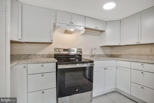 5018 Quimby Ave, Beltsville, MD 20705 - kitchen with stainless steel electric range oven, under cabinet range hood, white cabinetry, and a sink