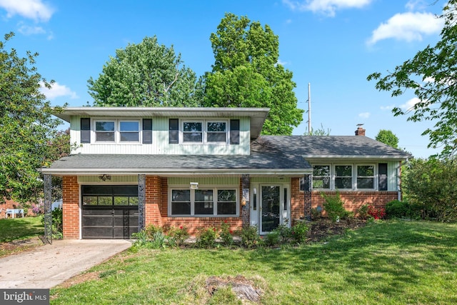 view of front facade featuring brick siding, a garage, a front lawn, and driveway