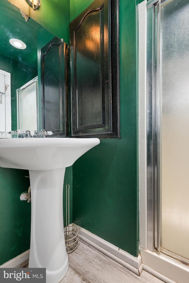 bathroom with baseboards and wood finished floors