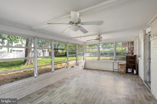 unfurnished sunroom with ceiling fan