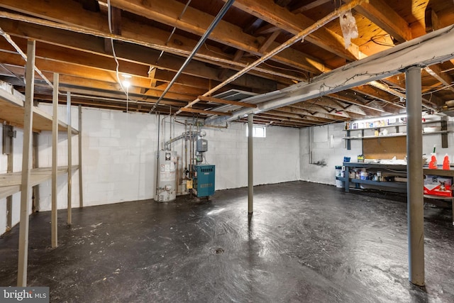 unfinished below grade area featuring a heating unit and gas water heater