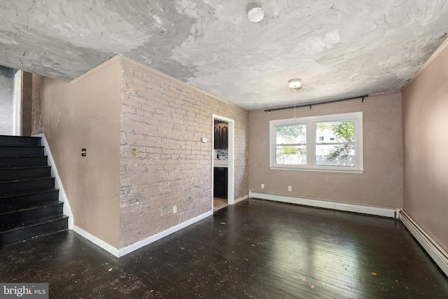 unfurnished living room with baseboards, a baseboard radiator, wood-type flooring, and stairs