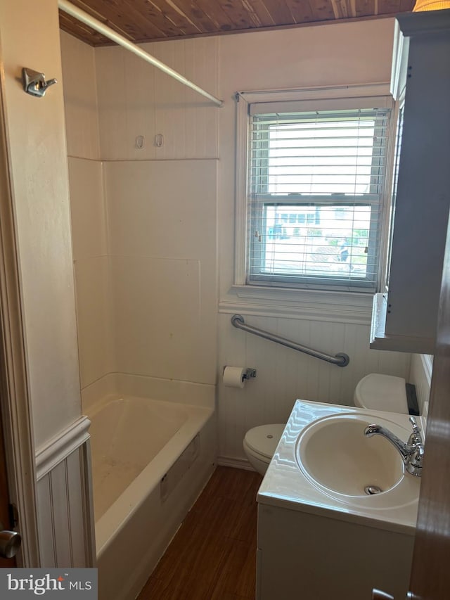 full bath featuring vanity, wood finished floors, bathing tub / shower combination, toilet, and wood ceiling