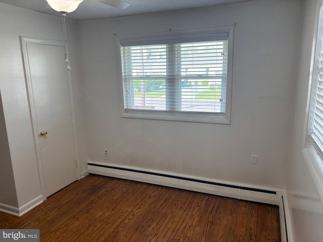 unfurnished bedroom with baseboards, a baseboard radiator, ornamental molding, and wood finished floors