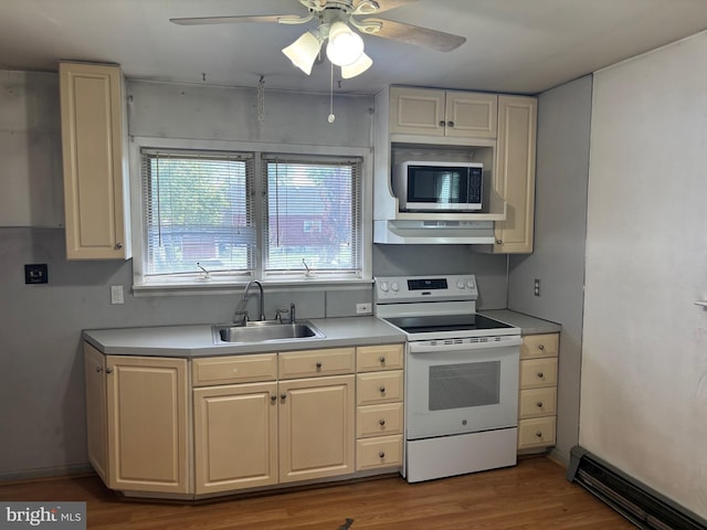 kitchen featuring a ceiling fan, white electric range, a sink, stainless steel microwave, and under cabinet range hood