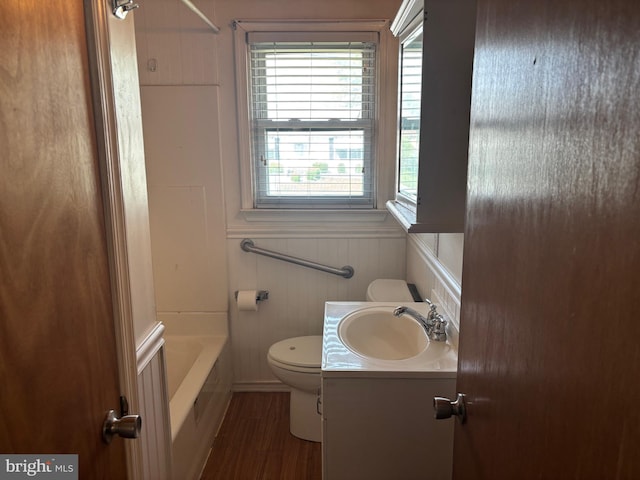 full bath featuring a healthy amount of sunlight, vanity, toilet, and wood finished floors