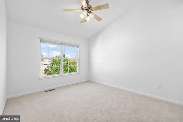 unfurnished room featuring baseboards, carpet flooring, lofted ceiling, and ceiling fan