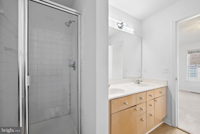 bathroom with a stall shower and double vanity