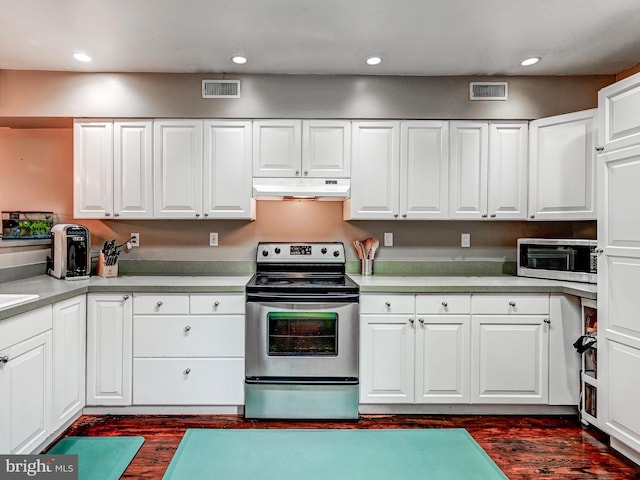2122 E Lombard St E, Baltimore, MD 21231 - kitchen with appliances with stainless steel finishes, under cabinet range hood, dark wood-style floors, white cabinets, and light countertops