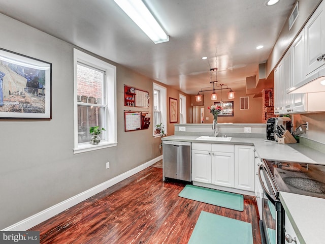2122 E Lombard St E, Baltimore, MD 21231 - kitchen featuring appliances with stainless steel finishes, a peninsula, dark wood-type flooring, white cabinets, and recessed lighting