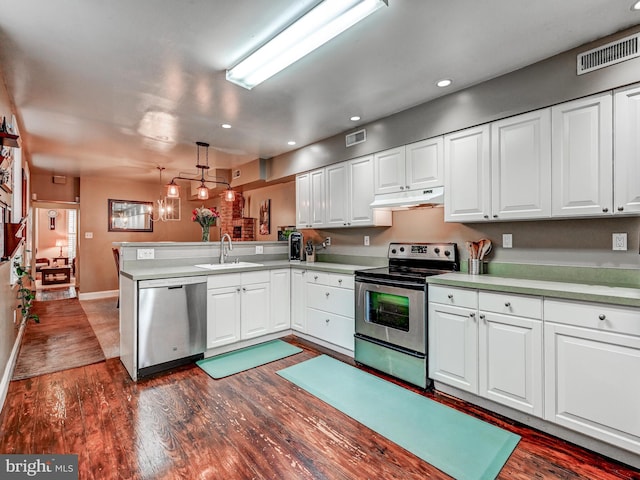 2122 E Lombard St E, Baltimore, MD 21231 - kitchen with appliances with stainless steel finishes, under cabinet range hood, a peninsula, recessed lighting, and dark wood-style floors