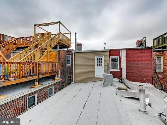 2122 E Lombard St E, Baltimore, MD 21231 - back of property featuring stairway, a wooden deck, and brick siding