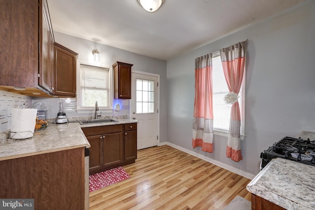 322-324 Washington Ave, Laurel Springs, NJ 08021 - kitchen featuring a sink, light countertops, baseboards, black gas range oven, and light wood-style flooring