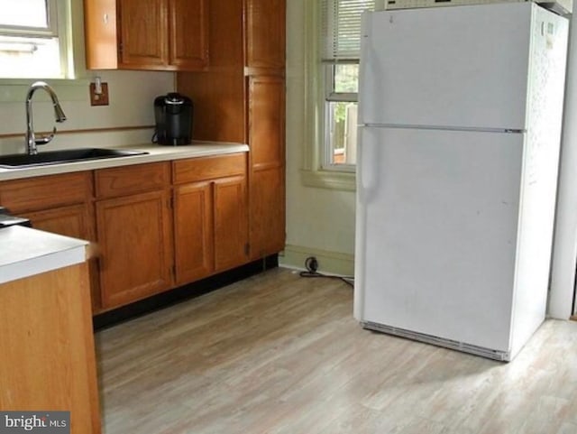 322-324 Washington Ave, Laurel Springs, NJ 08021 - kitchen featuring brown cabinets, a sink, light countertops, freestanding refrigerator, and light wood finished floors