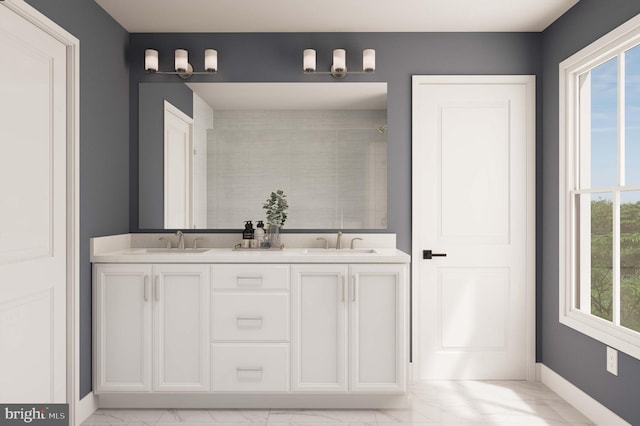 full bathroom featuring double vanity, baseboards, a sink, and marble finish floor