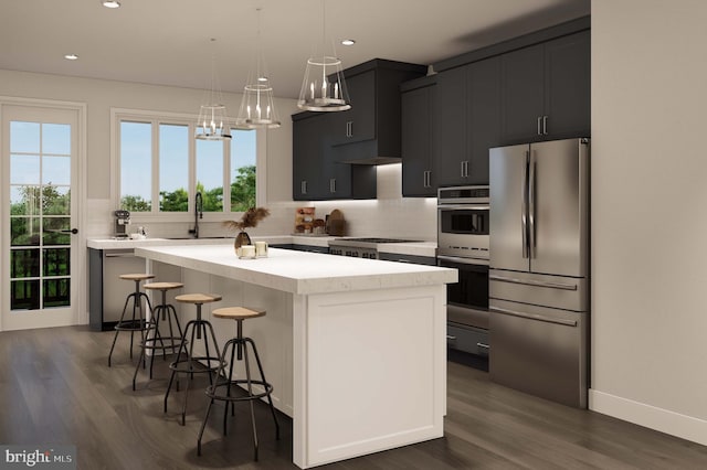 kitchen featuring a kitchen island, stainless steel appliances, a wealth of natural light, and a sink